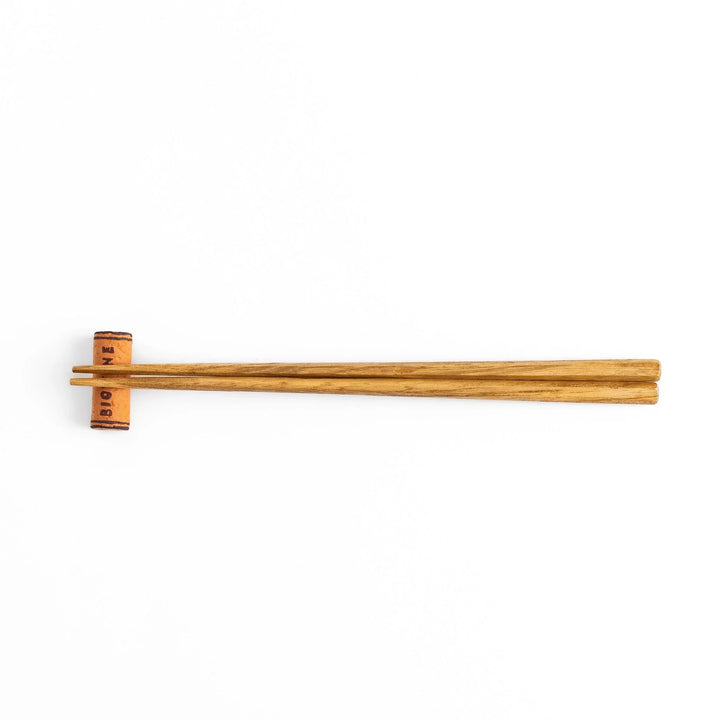 Fun chopstick rest shaped like a wine cork, featuring the word "BIOWINE" printed in bold on the side for a playful touch.
