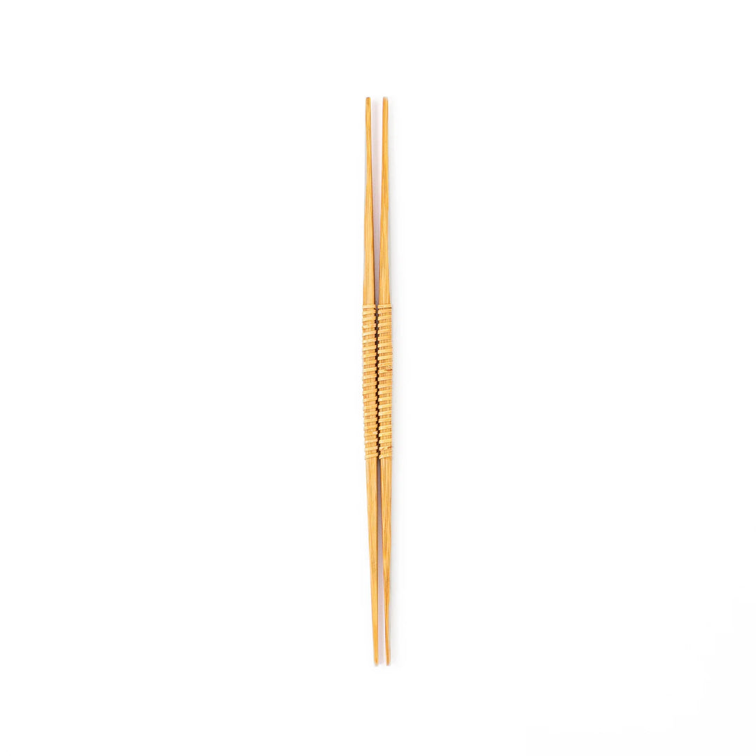 A pair of Japanese bamboo serving chopsticks featuring fine tapered tips on both ends and a textured wrapped center grip
