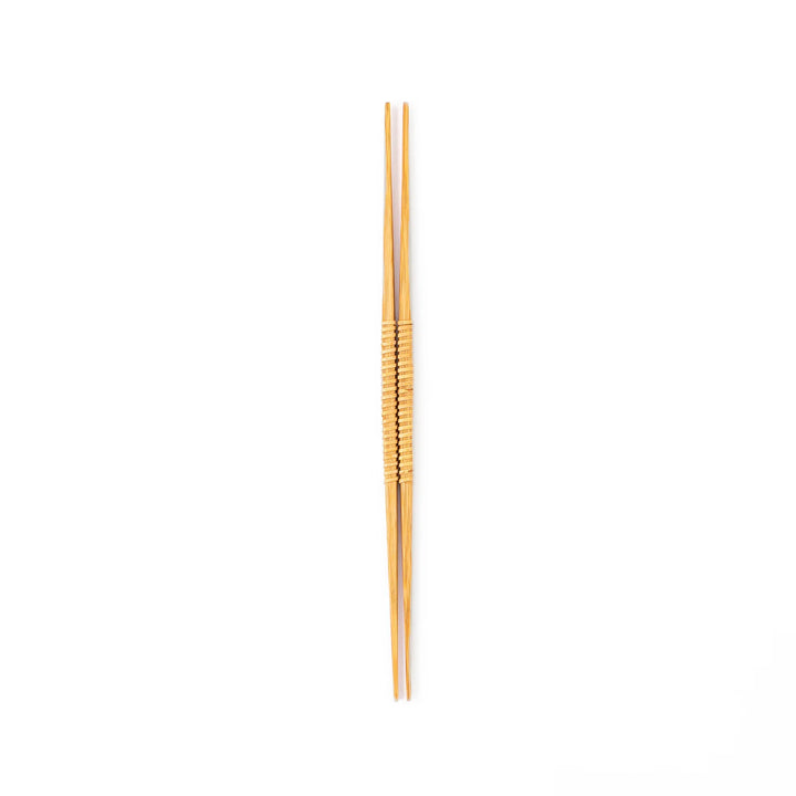 A pair of Japanese bamboo serving chopsticks featuring fine tapered tips on both ends and a textured wrapped center grip