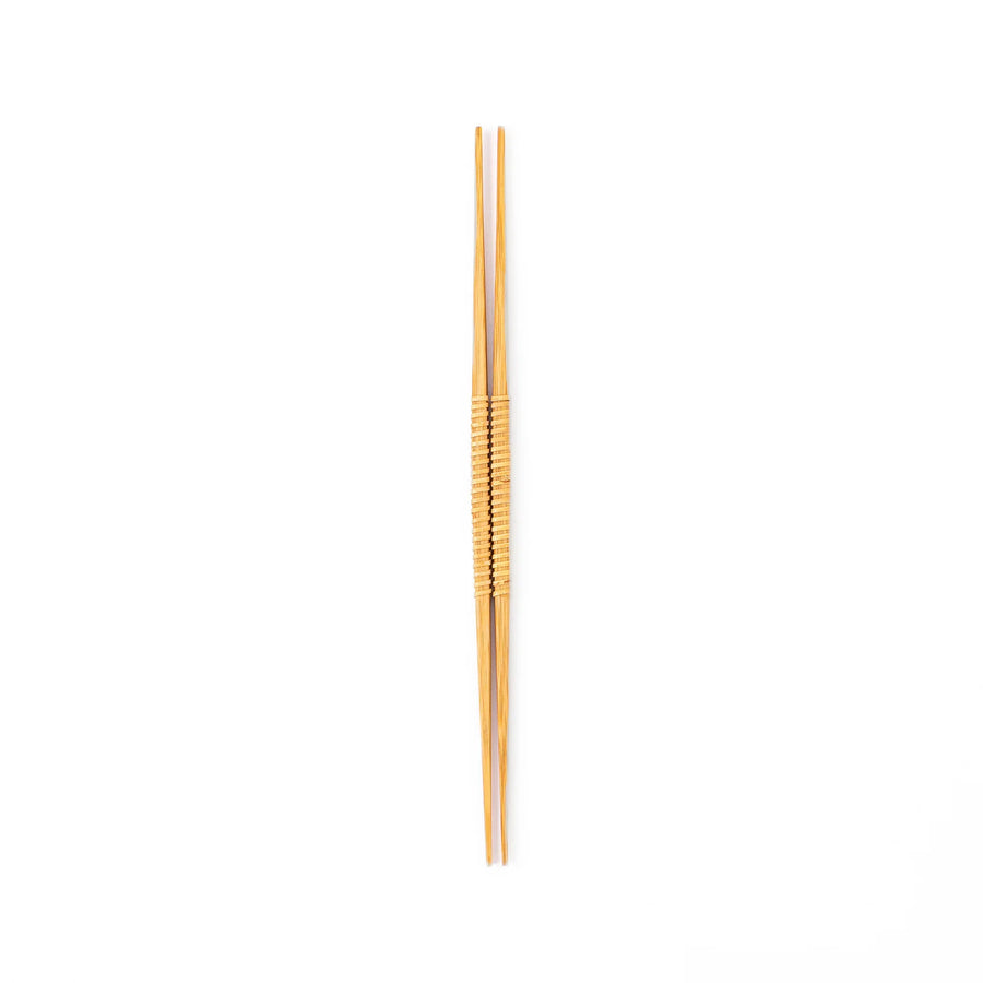A pair of Japanese bamboo serving chopsticks featuring fine tapered tips on both ends and a textured wrapped center grip