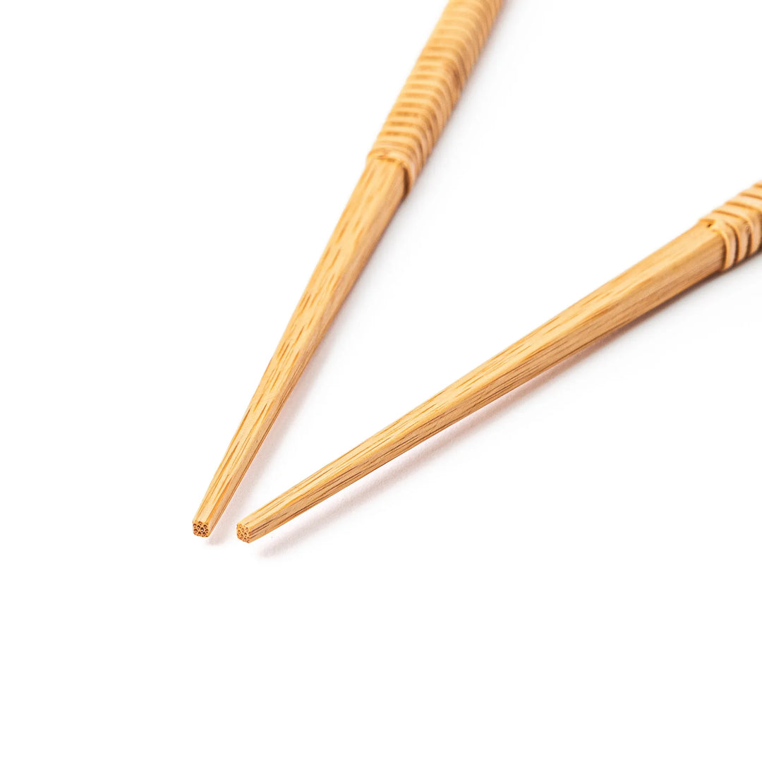 A pair of Japanese bamboo serving chopsticks featuring fine tapered tips on both ends and a textured wrapped center grip