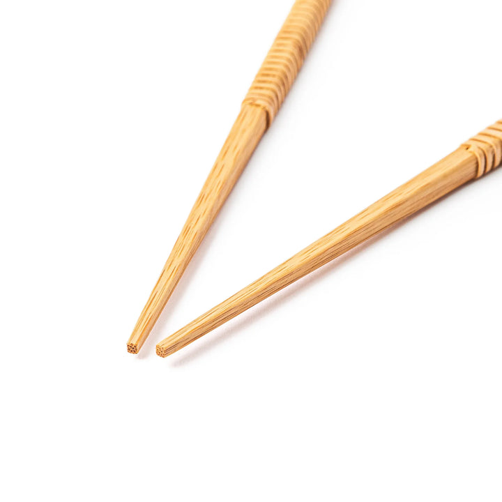 A pair of Japanese bamboo serving chopsticks featuring fine tapered tips on both ends and a textured wrapped center grip
