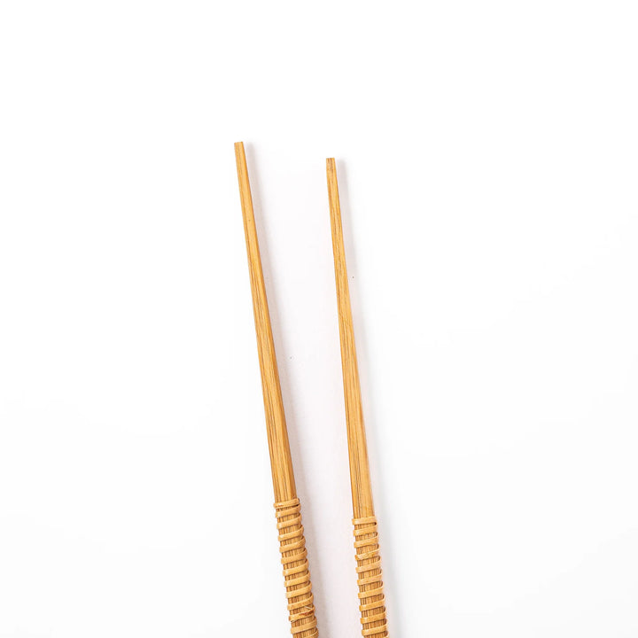 A pair of Japanese bamboo serving chopsticks featuring fine tapered tips on both ends and a textured wrapped center grip