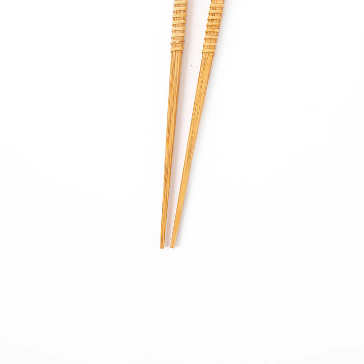 A pair of Japanese bamboo serving chopsticks featuring fine tapered tips on both ends and a textured wrapped center grip