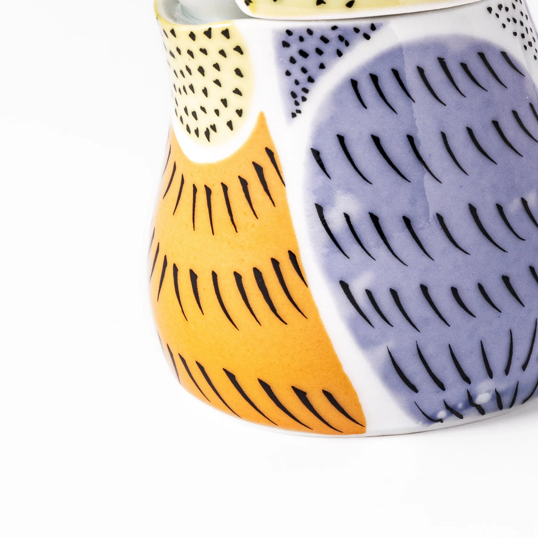 Bird-shaped soy sauce dispenser with purple and yellow hand-painted details, adding a playful touch to your table.