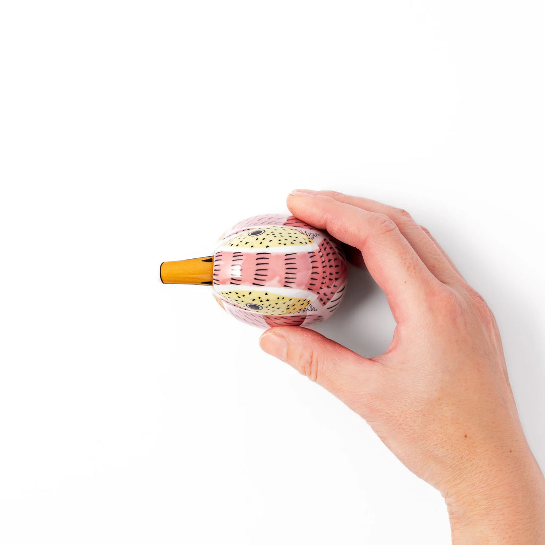 Bird-shaped soy sauce dispenser with pink and yellow hand-painted details, adding a playful touch to your table.