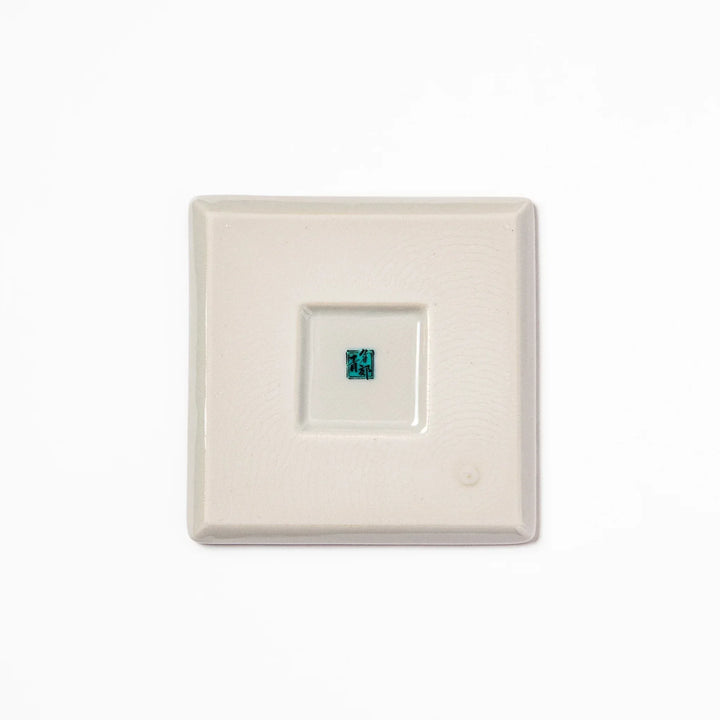 Square Japanese ceramic coaster with yellow peony flowers and teal leaves adding elegance to any table.