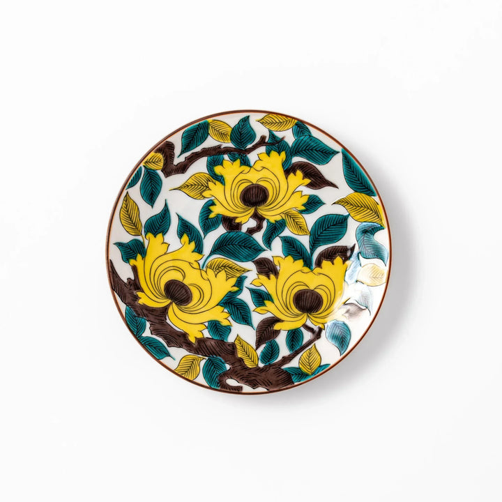 Japanese porcelain dessert plate with bold yellow peony blooms, green leaves, and brown branches on a white background