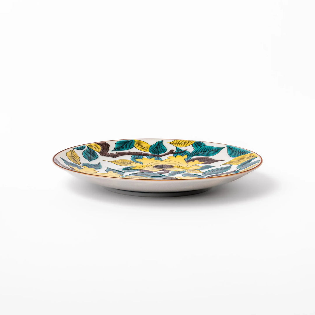 Japanese porcelain dessert plate with bold yellow peony blooms, green leaves, and brown branches on a white background