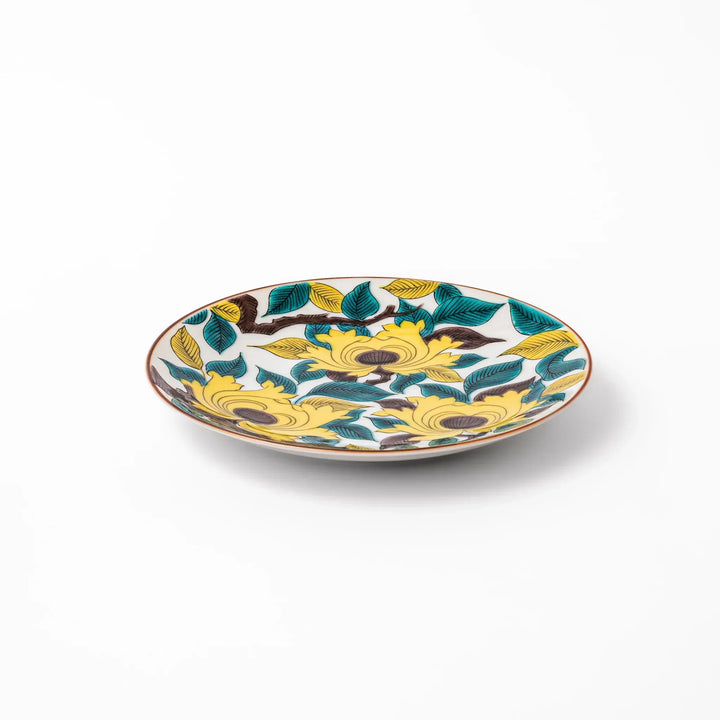 Japanese porcelain dessert plate with bold yellow peony blooms, green leaves, and brown branches on a white background