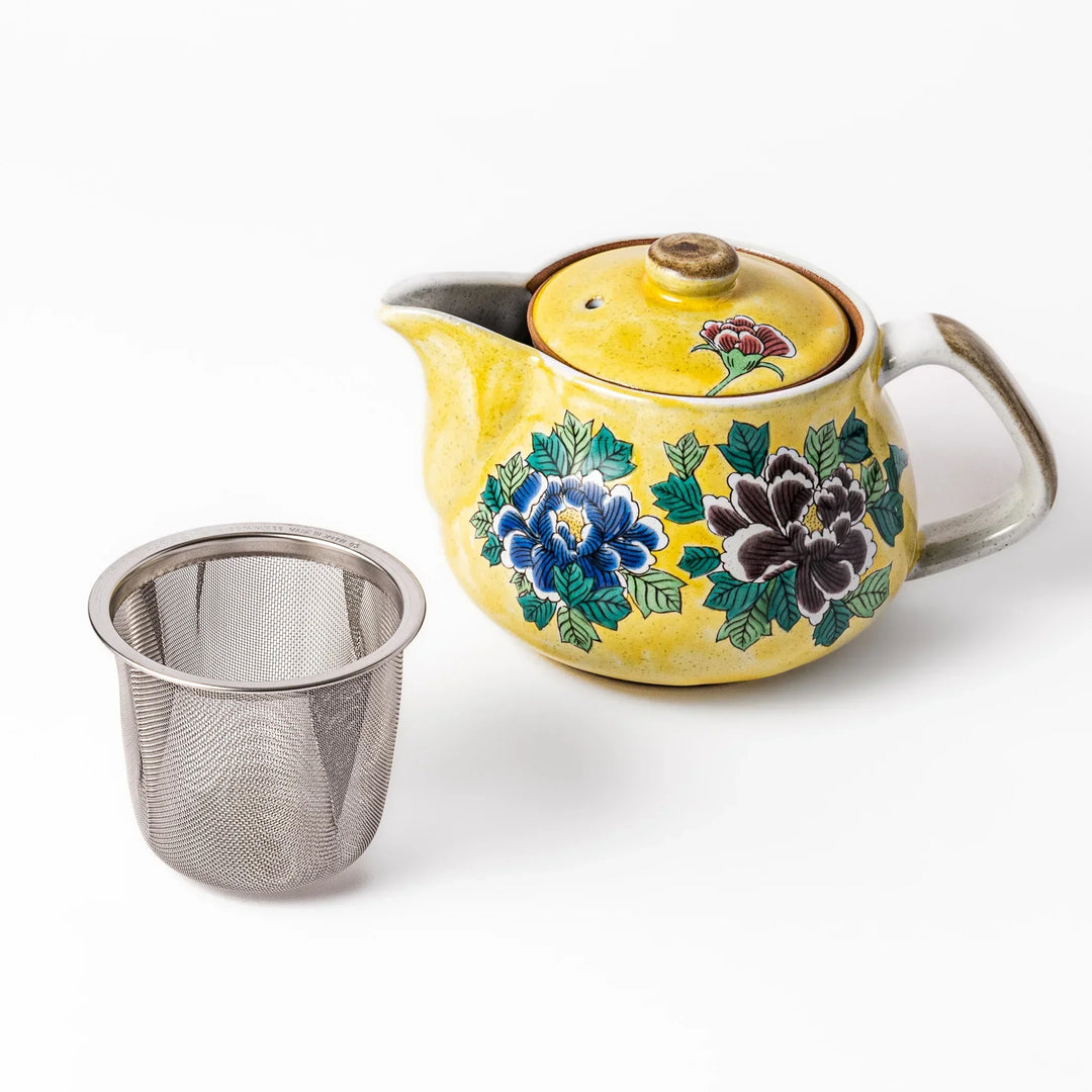 Yellow ceramic teapot with hand painted peony flowers in rich tones and stainless steel tea strainer.