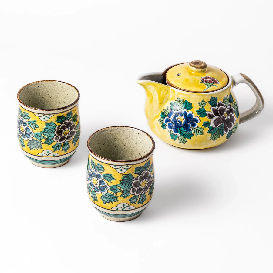 Three piece Japanese ceramic tea set with yellow glaze hand painted peony flowers teapot and matching cups.