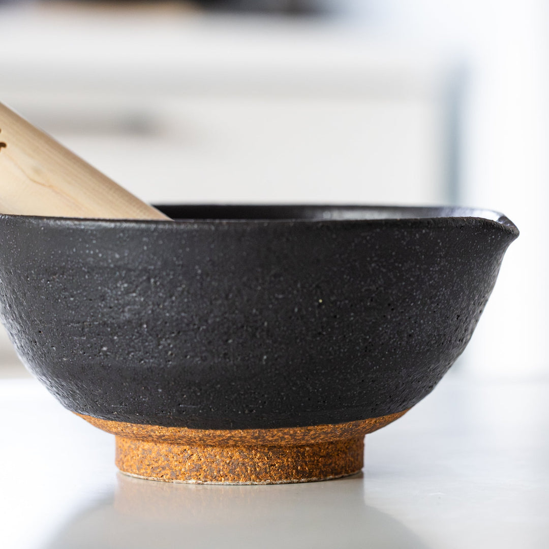 Japanese suribachi mortar with rustic black ceramic finish and textured surface