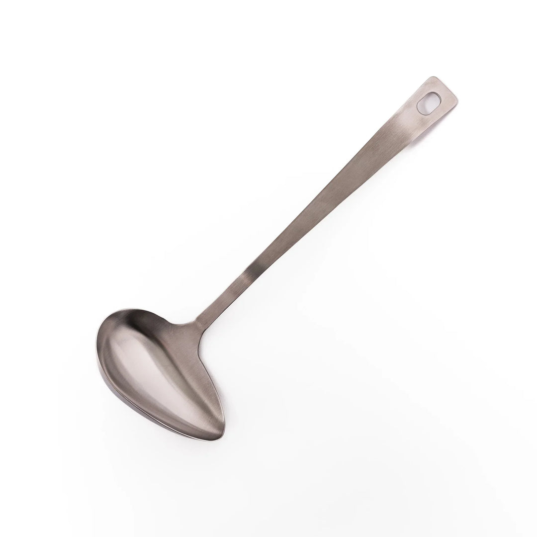Japanese stainless steel soup ladle with long handle and deep curved bowl for serving soups and stews.