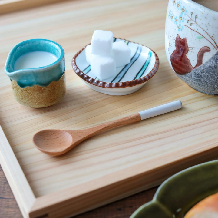 Minimalist beech wood spoon with slender handle tipped in crisp white, ideal for scooping tea or sugar with elegance.