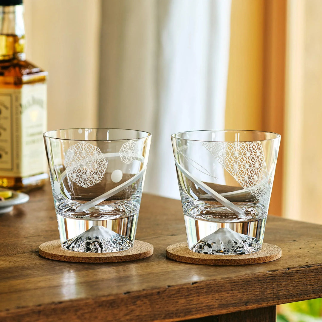 Two empty kiriko-cut whiskey glasses from Japan, featuring Mt. Fuji bases and elegant geometric engravings.