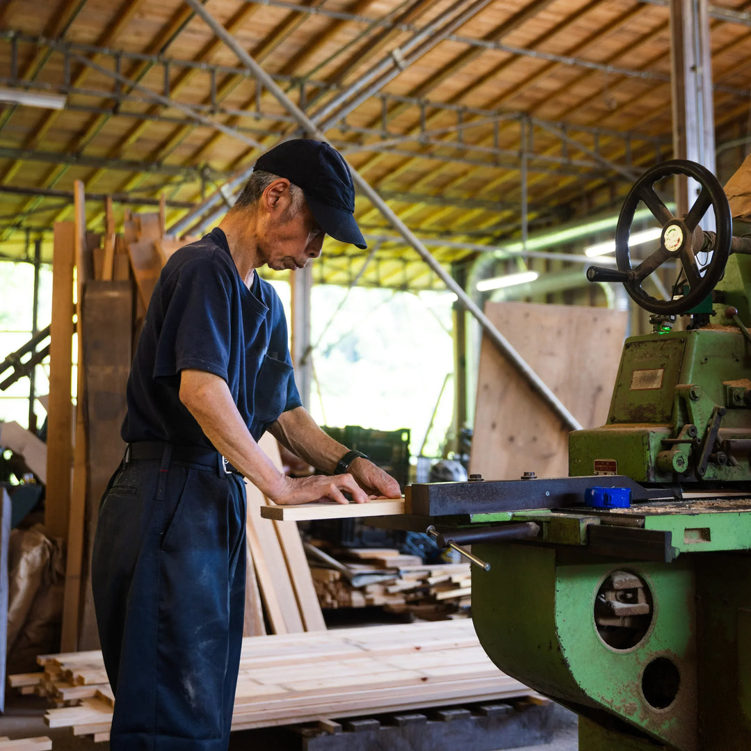 Craftsman shaping hinoki wood board inside Tosaryu workshop for Japanese kitchen tools production