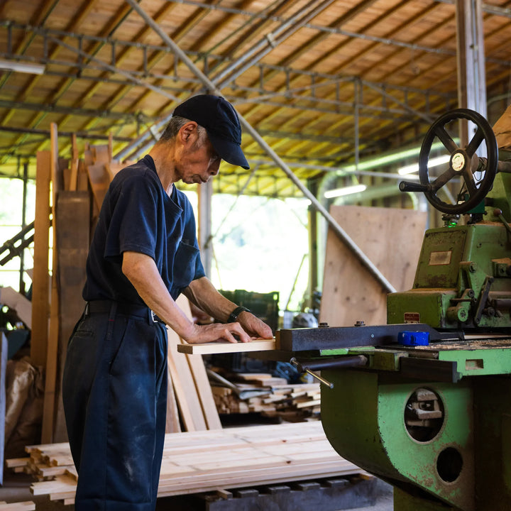 Craftsman shaping hinoki wood board inside Tosaryu workshop for Japanese kitchen tools production