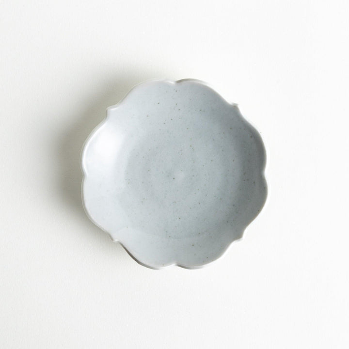 A small ceramic plate with a cloud-like shape, featuring a smooth white finish.