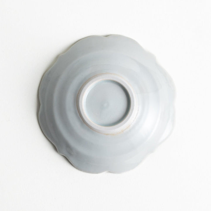 A small ceramic plate with a cloud-like shape, featuring a smooth white finish.