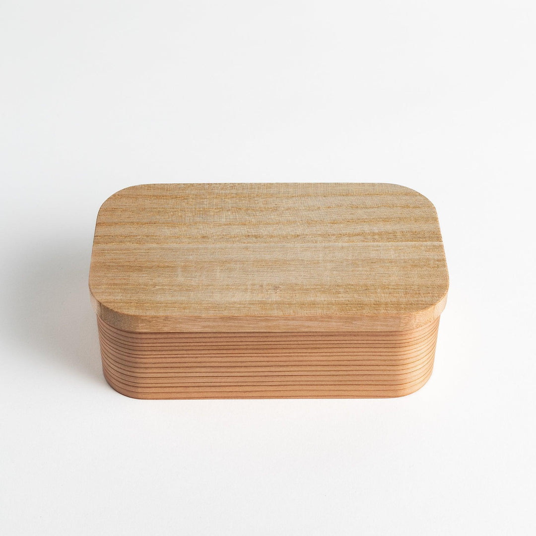 Artisan Cedar Bento Box with smooth wood finish and rounded edges, showcasing its elegant design.