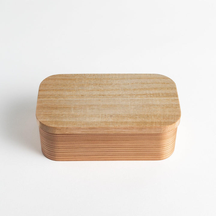 Artisan Cedar Bento Box with smooth wood finish and rounded edges, showcasing its elegant design.