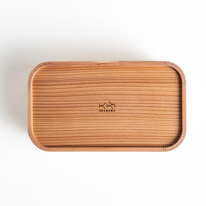 Cedar bento box with lid showing natural wood grain and rounded edges for minimalist Japanese look.