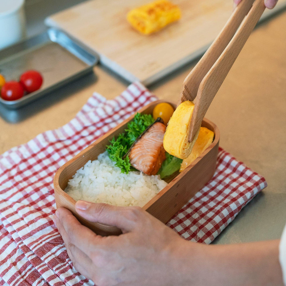 Artisan Cedar Bento Box with smooth wood finish and rounded edges, showcasing its elegant design.