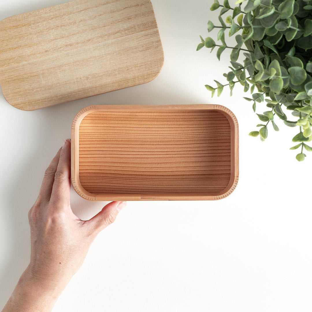 Opened Artisan Cedar Bento Box, revealing a spacious interior with a natural wood finish and seamless design.