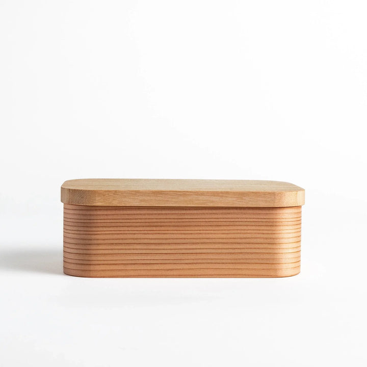 Artisan Cedar Bento Box with its lid removed, revealing the well-crafted interior and fine wooden texture.