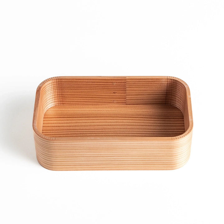 Close-up of Artisan Cedar Bento Box, showing detailed wood grain and the neat finish along the edges.