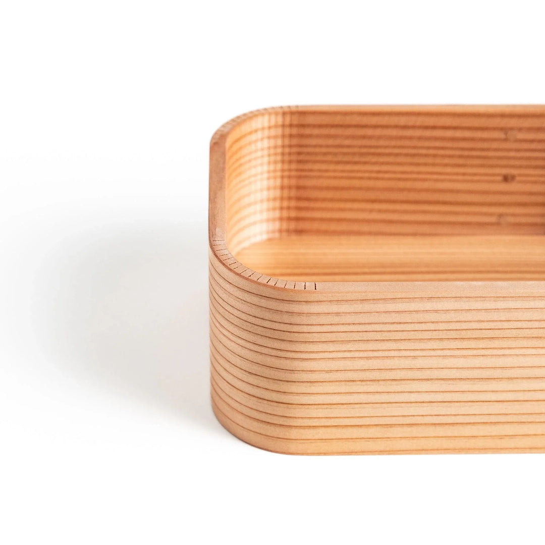 Detailed close-up of the corner and wood grain of the Artisan Cedar Bento Box interior.