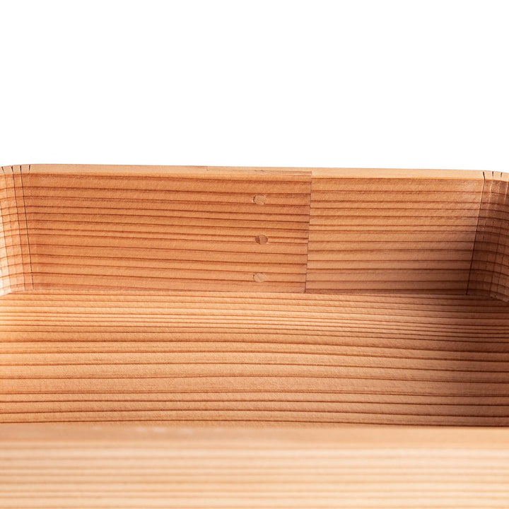 Cedar bento box with lid showing natural wood grain and rounded edges for minimalist Japanese look.