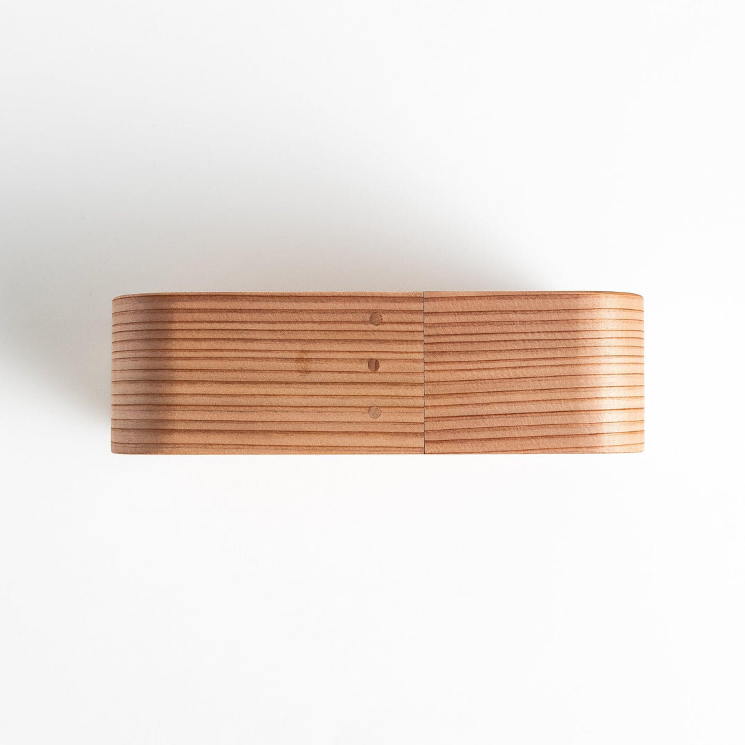 Close-up of the Artisan Cedar Bento Box lid, highlighting its sleek finish and minimalistic design.