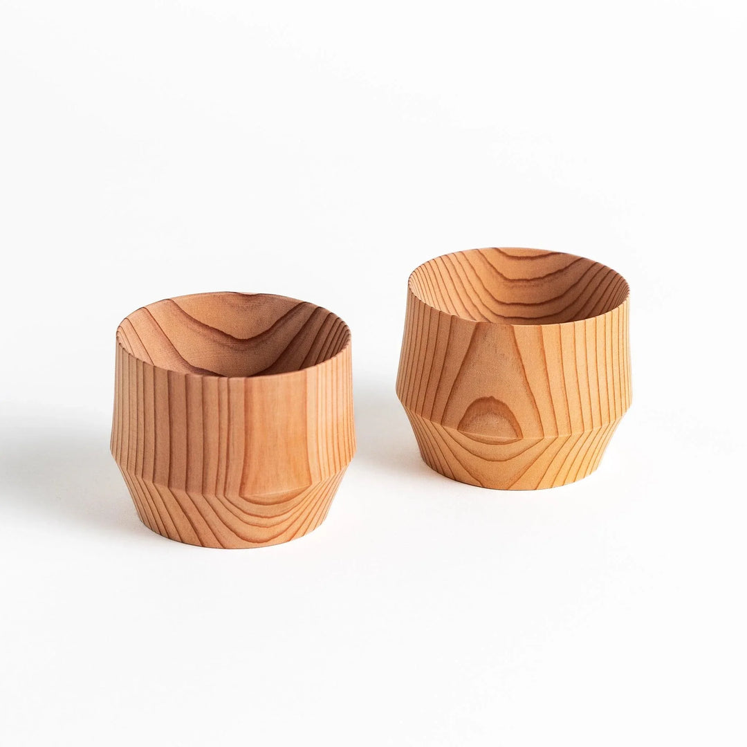 Detailed side view of a cedar sake cup with smooth contours and a natural wood grain design, highlighting its unique texture.