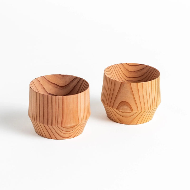 Detailed side view of a cedar sake cup with smooth contours and a natural wood grain design, highlighting its unique texture.