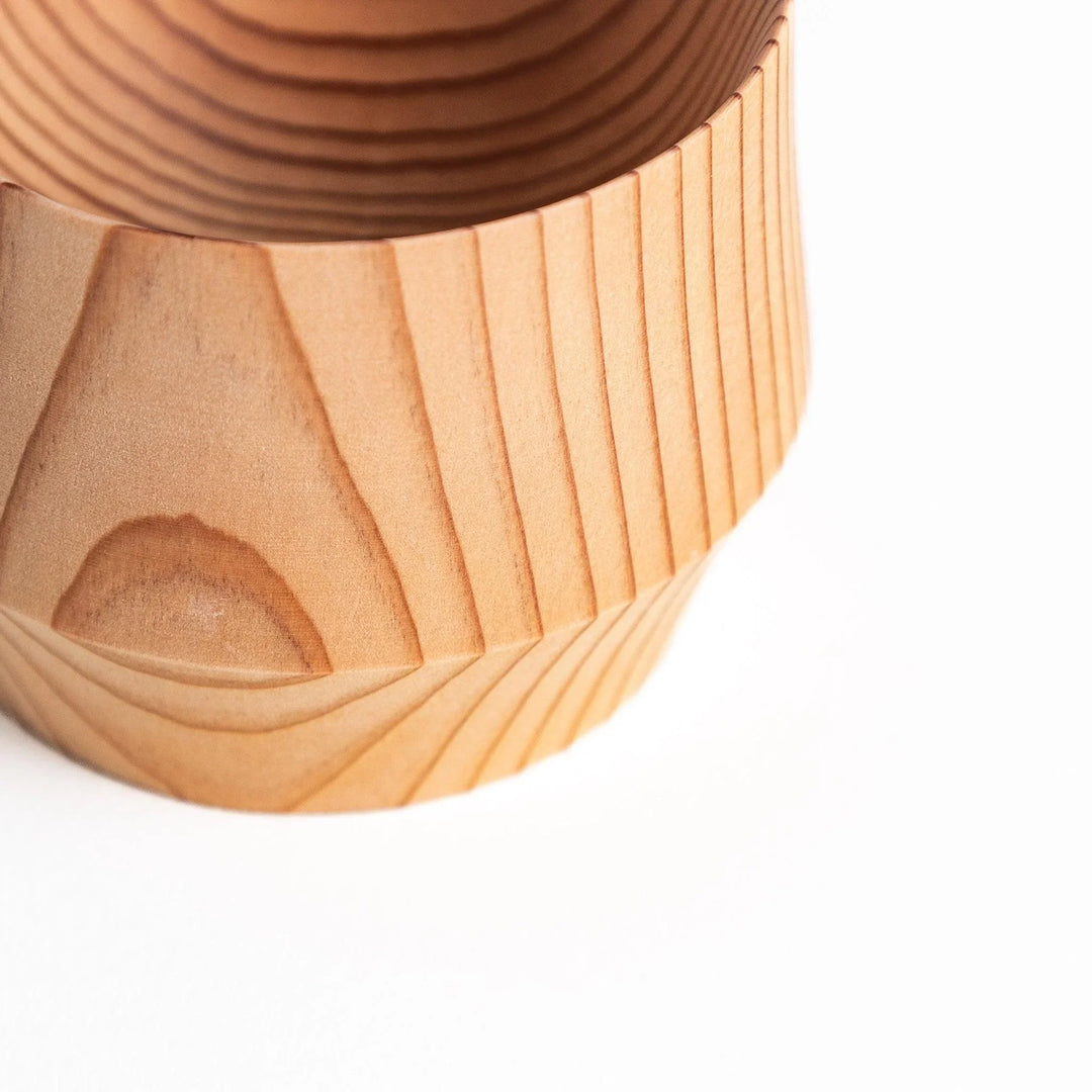 Artisan cedar sake cups showcasing natural wood grain and smooth finish offering warmth and elegance to dining.