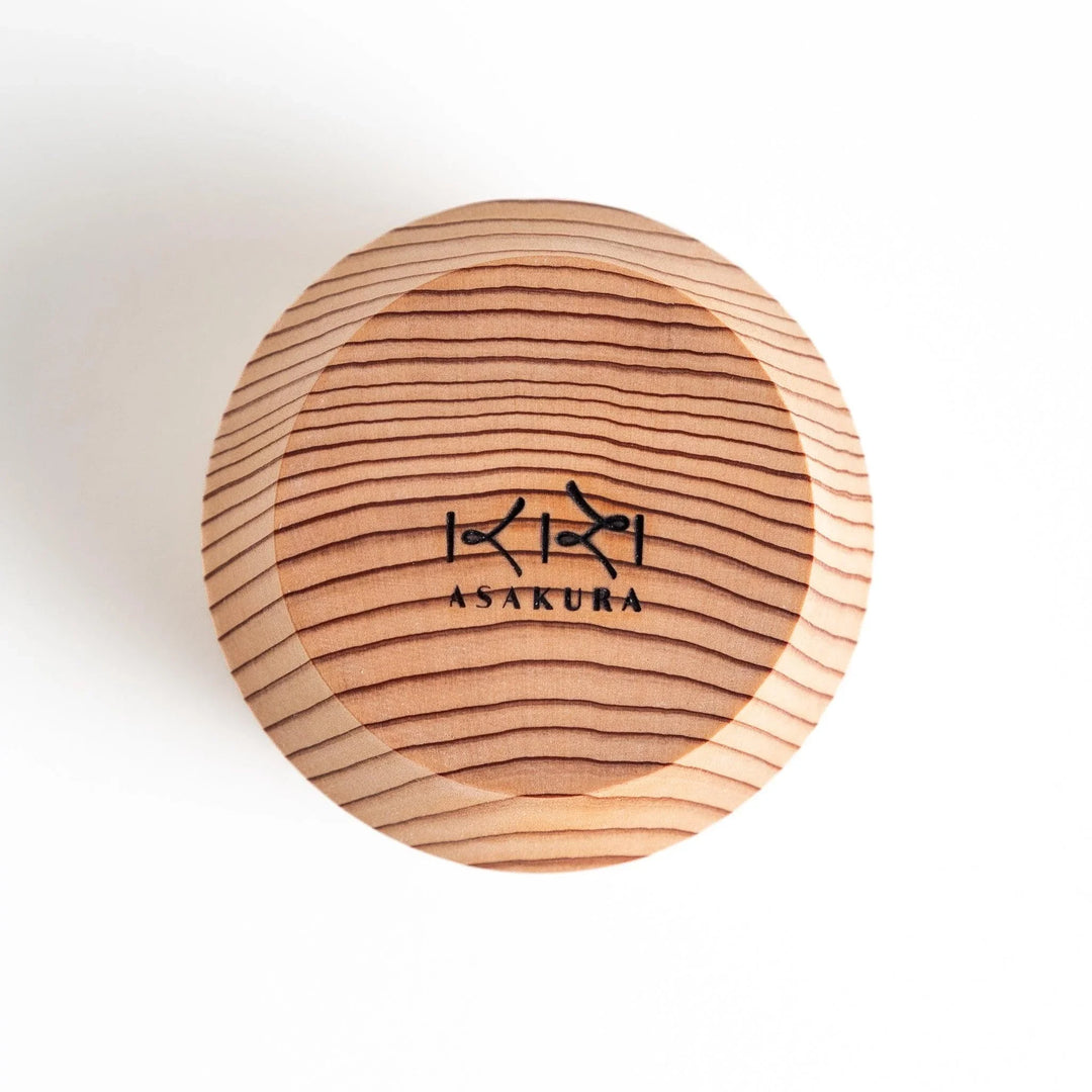 Set of Artisan Cedar Sake Cups with a natural wood grain design, perfect for serving traditional sake.