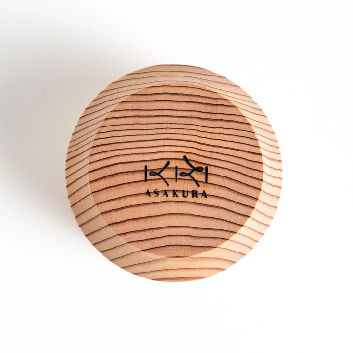 Set of Artisan Cedar Sake Cups with a natural wood grain design, perfect for serving traditional sake.