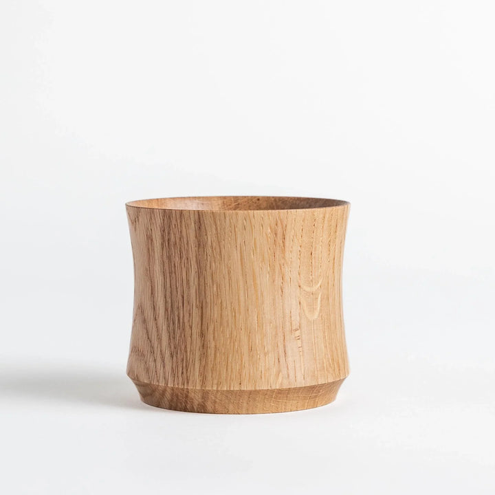 Pair of Mizunara oak whisky cups with smooth curves and rich grain pattern perfect for fine spirits.