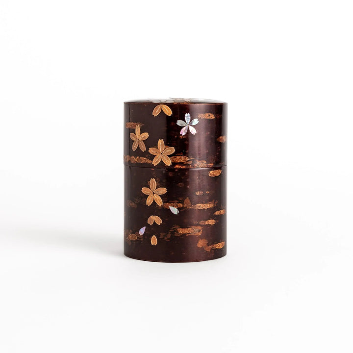 Elegant cherry bark tea caddy with mother-of-pearl cherry blossom inlay, perfect for storing and preserving fine tea leaves.