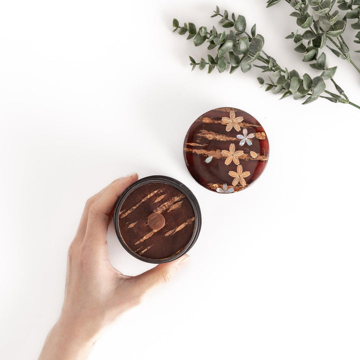 Cherry bark tea caddy with mother of pearl blossom inlay in wooden box perfect for storing fine tea.
