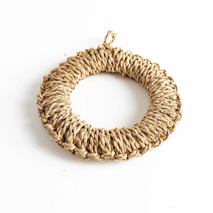 Natural straw trivet with woven pattern ideal for placing hot dishes or pots adding simple stylish touch to kitchen.