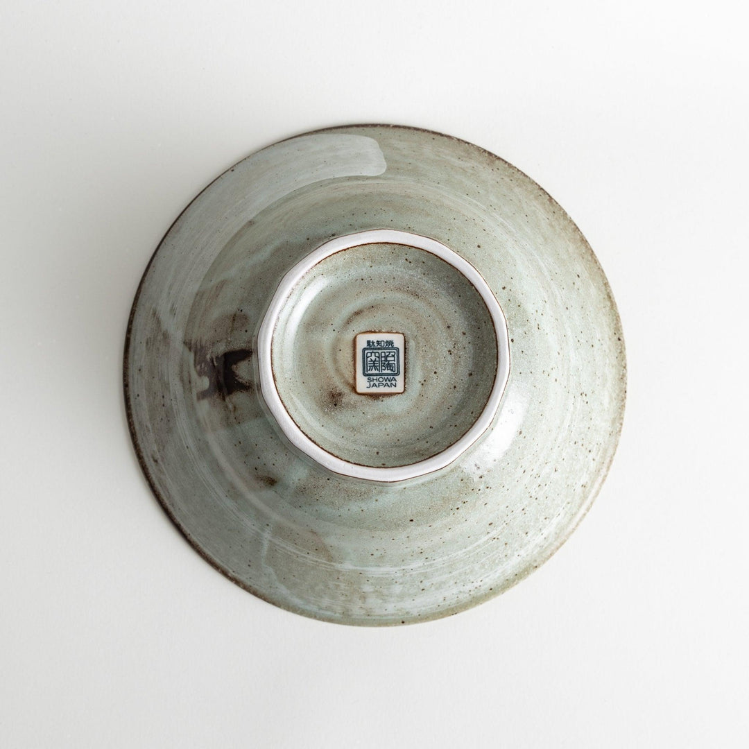 A light gray, wide-rimmed bowl with a textured and speckled surface.