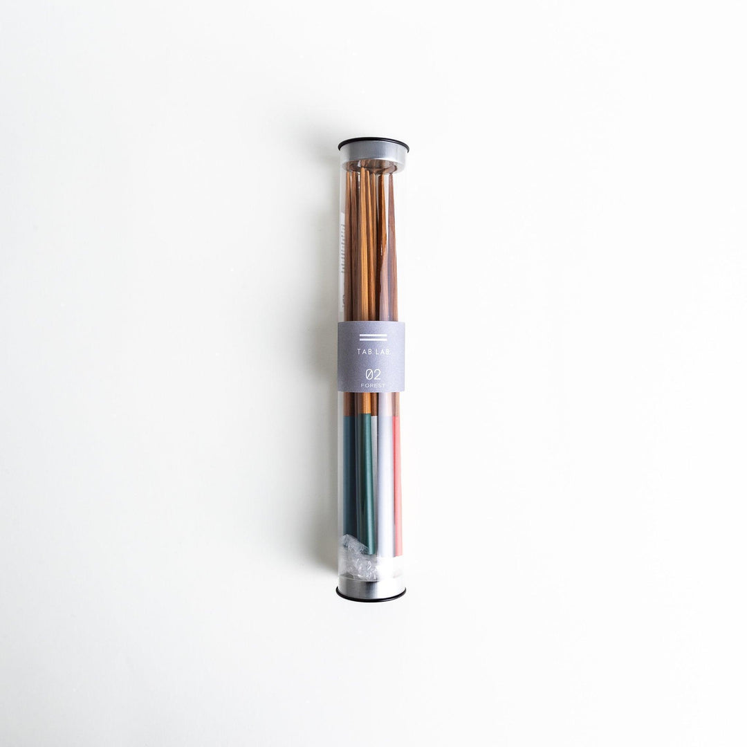 A set of wooden chopsticks with vibrant colored tops in various shades, including yellow, blue, orange, green, and white.