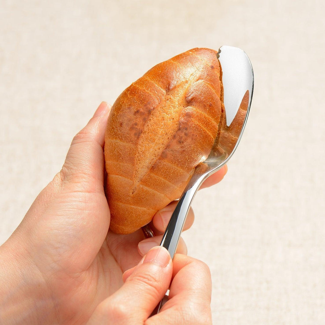 Stainless steel spreader knife with a serrated edge and sleek design