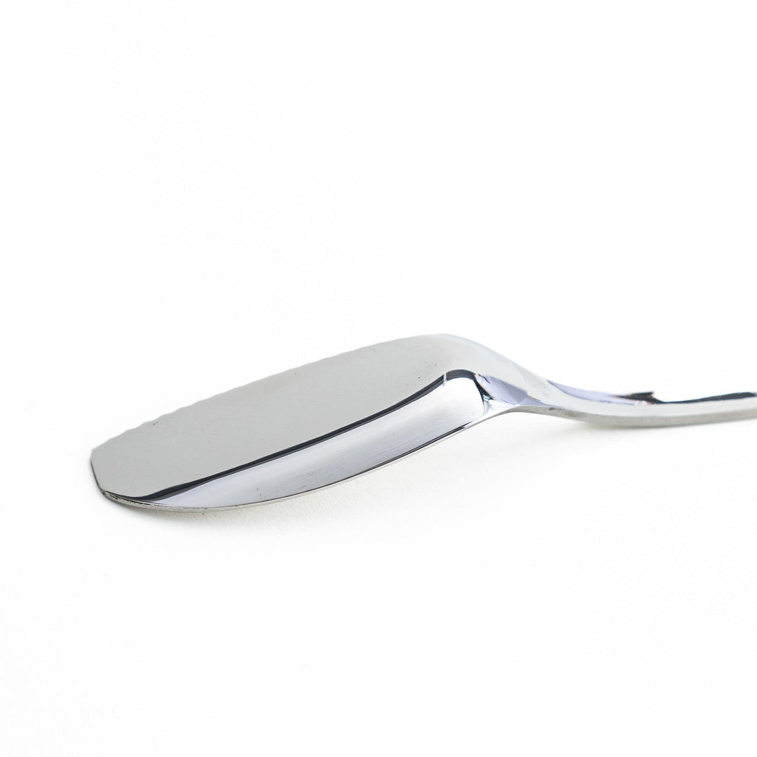 Stainless steel spreader knife with a serrated edge and sleek design
