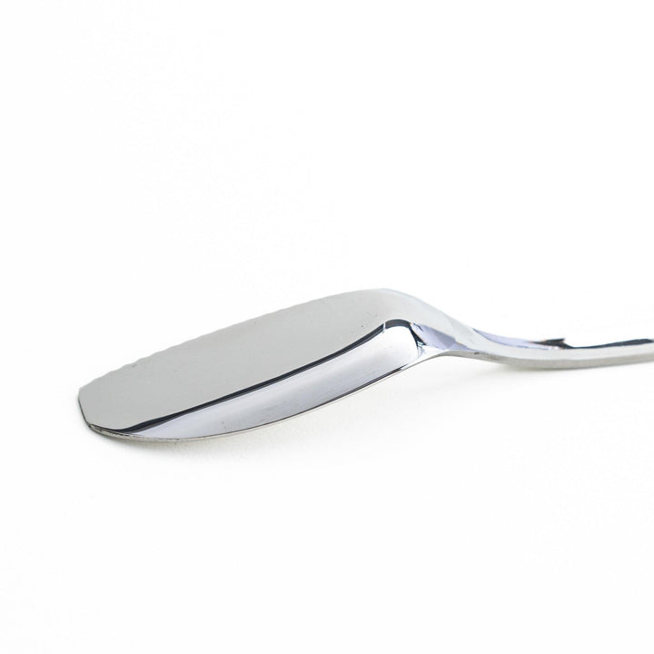 Stainless steel spreader knife with a serrated edge and sleek design