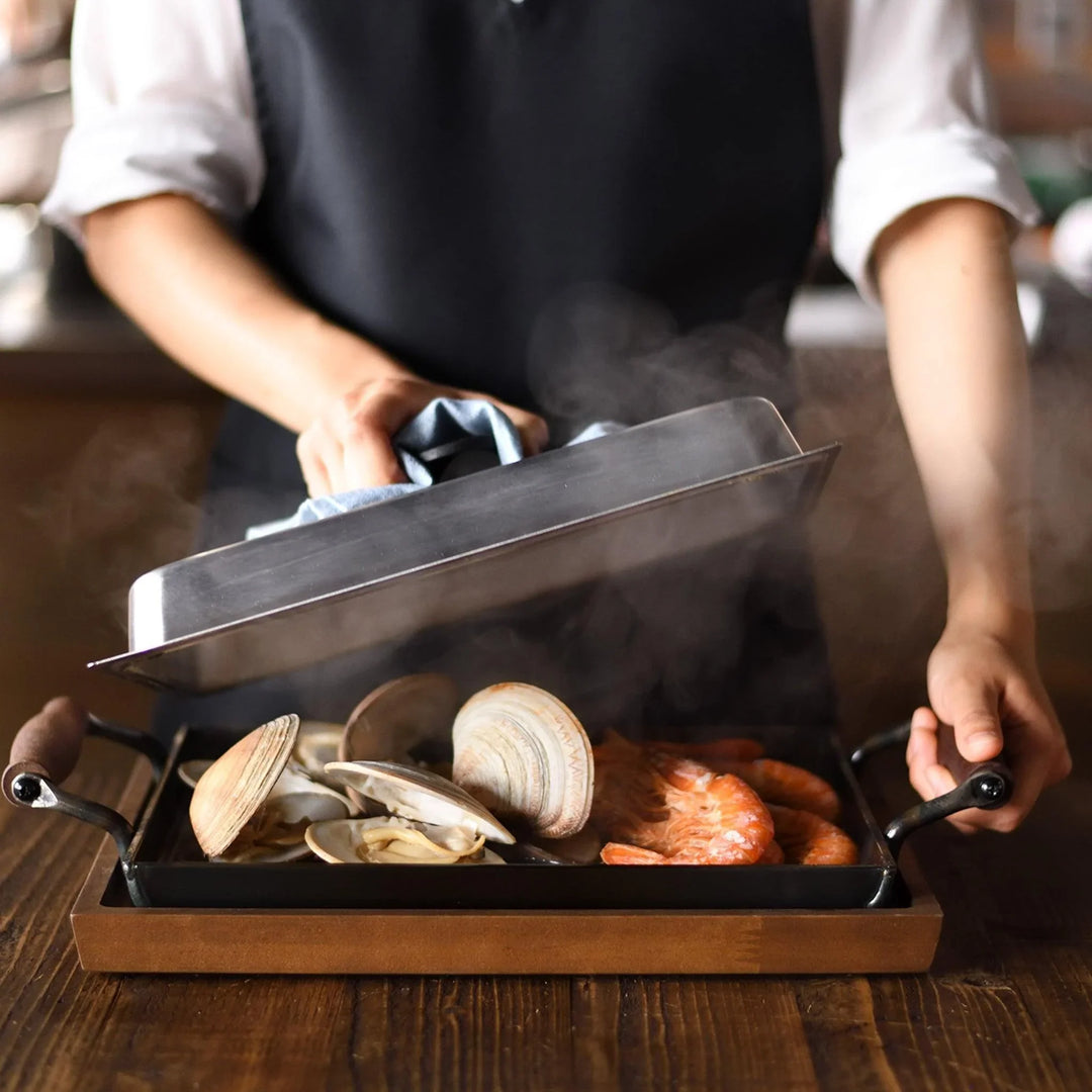 Rectangular teppanyaki grill pan with wooden handles on both sides with stainless steel lids