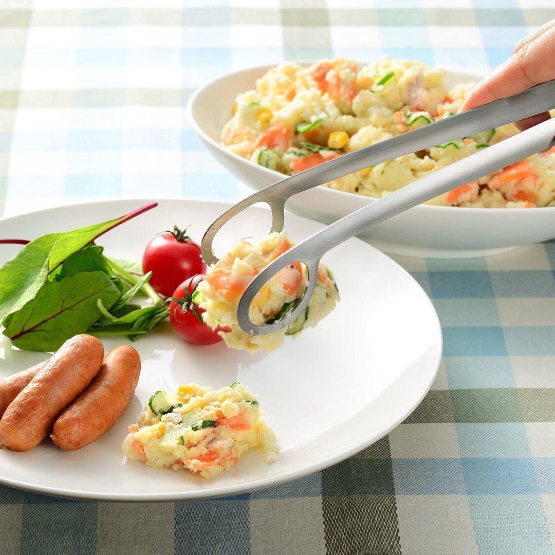 Curved stainless steel tongs with holes at the end for drainage